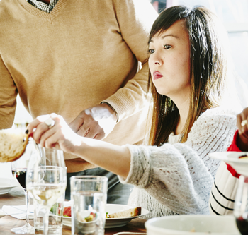 Woman looking unhappy at a Thanksgiving dinner