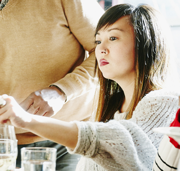 Woman looking unhappy at a Thanksgiving dinner