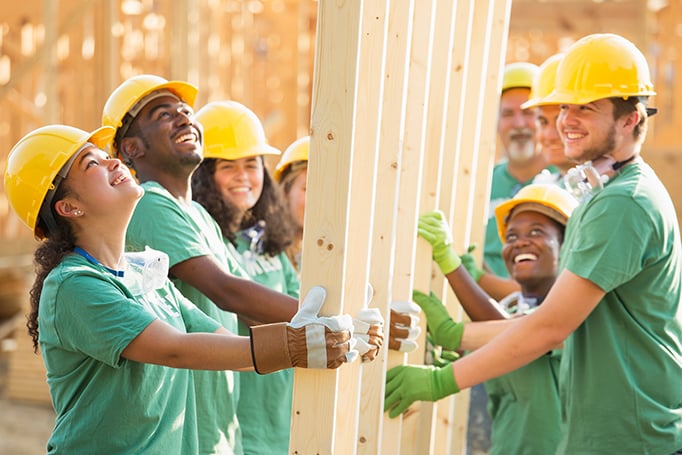 Group of volunteers putting up a wall