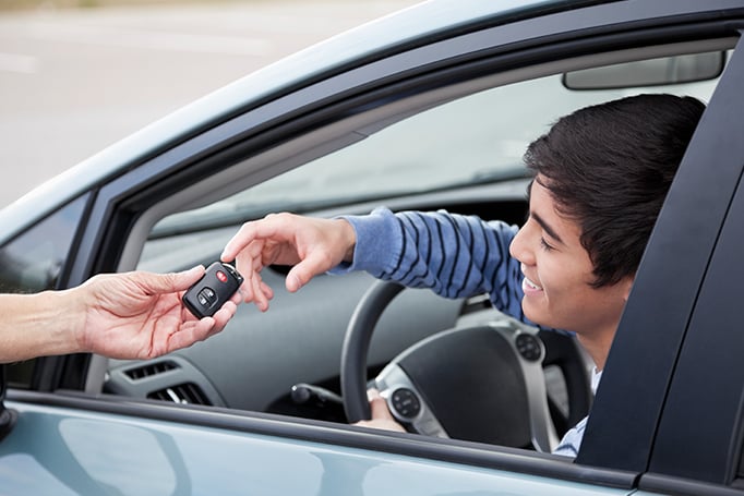 Young man being handed car keys