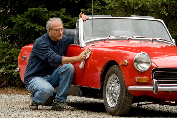 Man admiring his older car