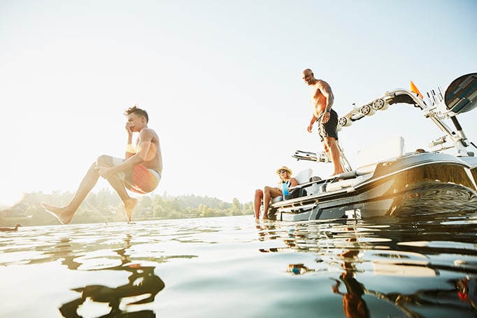 Family jumping off boat into water